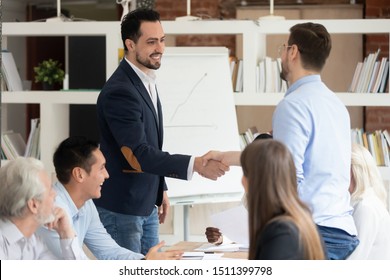 Businesspeople Gathered At Office Meeting Middle East Appearance And Caucasian Businessmen Shake Hands, Making Agreement Closing Deal, Business Partners Handshaking After Successful Group Negotiations