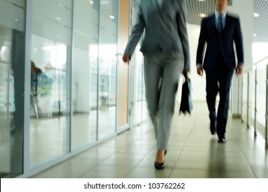 Businesspeople Going Along Corridor Inside Office Building