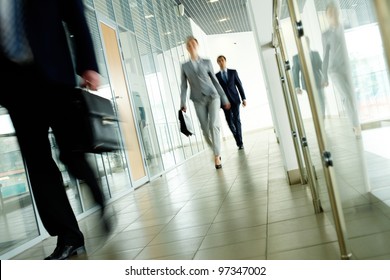 Businesspeople Going Along Corridor Inside Office Building