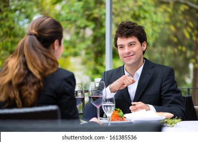 Businesspeople Having Business Lunch Outside On The Terrace In A Fine Dining Restaurant