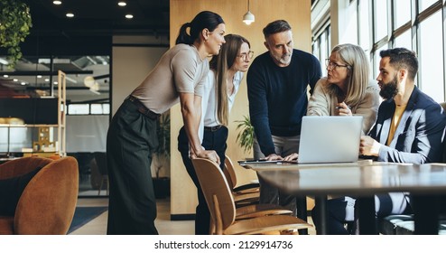 Businesspeople having a discussion while collaborating on a new project in an office. Group of diverse businesspeople having a meeting together in a modern workspace. - Shutterstock ID 2129914736