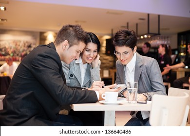 businesspeople having leisure time together in  cafe