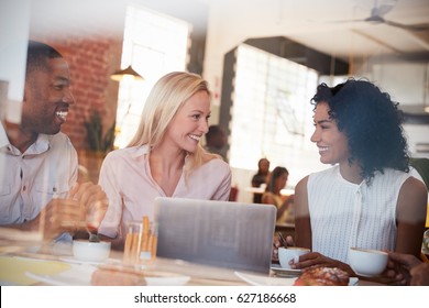 Businesspeople Meeting In Coffee Shop Shot Through Window