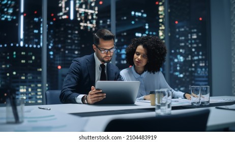 Businesspeople in Modern Office: Business Meeting of Two Managers. Accountant and Operations Director Talk, Discuss, Brainstorm Corporate Strategy, Implementing Budget and Financial Plans. Night. - Shutterstock ID 2104483919