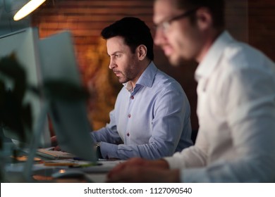 Businesspeople In The Office At Night Working Late