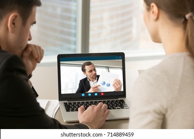 Businesspeople participate video conference looking at laptop screen during virtual meeting with investor for startup, discussing financial document online, videocall webcam app for business, close up - Powered by Shutterstock