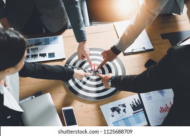 Businesspeople Point to a darts aiming at the target center business,Targeting the business concept. - Shutterstock ID 1125688709