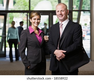 Businesspeople Posing In Office Lobby