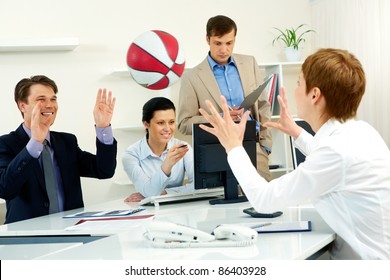 Businesspeople Throwing Basketball In The Office