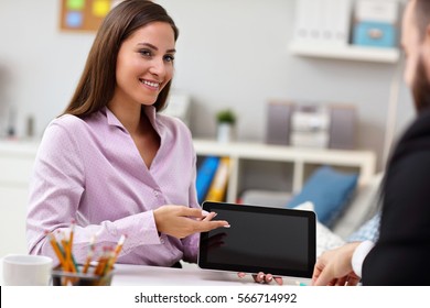 Businesspeople using their tablet - Shutterstock ID 566714992