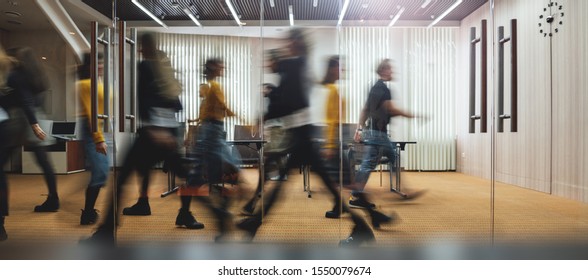 Businesspeople walking at modern office. Group of business employees at coworking center. Motion blur. Concept work process. Wide image - Shutterstock ID 1550079674