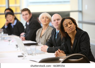 Businesspeople Watch Presentation In Board Room