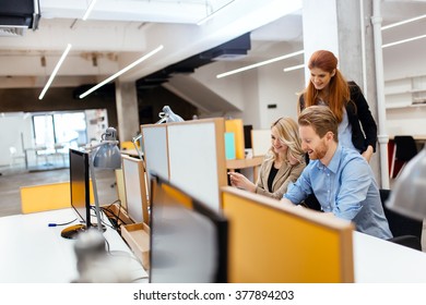Businesspeople working in modern office and collaborating - Shutterstock ID 377894203