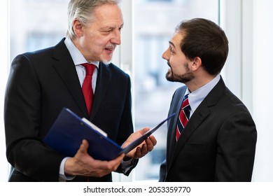 Businesspeople working together analyzing documents - Shutterstock ID 2053359770