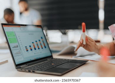 Businesspeople working together in a modern office, analyzing statistics and conducting market research. Positive teamwork for successful project development and digital marketing strategies. - Powered by Shutterstock