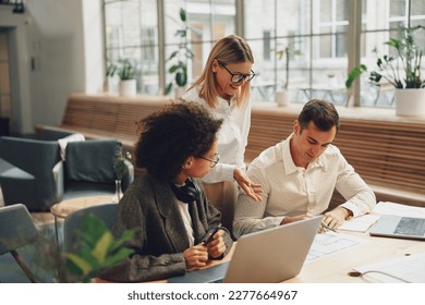 Businesspeople working together on new project in modern office. Teamwork concept - Shutterstock ID 2277664967