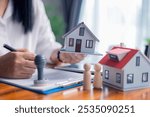 Businessperson decided to buy new home, securing loan to finance property and obtaining insurance for house, with the real estate agent facilitating sale and handing over home key. insurance, estate.