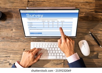 Businessperson Filling Online Survey Form On Digital Laptop