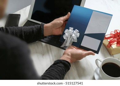 Businessperson Hands Holding New Gift Card Or Credit Card,digital Tablet Computer Dock Keyboard,smart Phone On Marble Desk