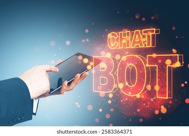 Businessperson holding a tablet with glowing Chat Bot text, colorful lights, and bokeh effect on a blue background. Concept of digital communication