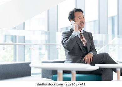 Businessperson making a phone call on his smartphone - Powered by Shutterstock