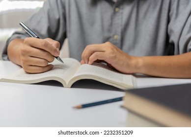 Businessperson reading and writing on book.education studying knowledge development and cognition learning concept. - Shutterstock ID 2232351209
