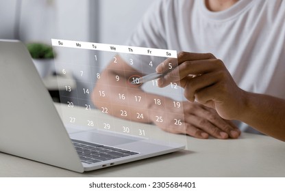 Businessperson or secretary manages time for effective work. Calendar on the virtual screen interface. Highlight appointment reminders and meeting agenda on the calendar. Time management concept.
 - Powered by Shutterstock