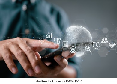 A businessperson with a smartphone. Finance and banking, digital link technology, and big data are all examples of business global internet connection application technology. - Shutterstock ID 2159651517