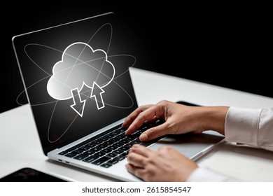 Businessperson using a laptop with cloud computing icon on the screen. Technology innovation on a virtual screen. Concept of Cloud computing technology, data storage, networking, and internet service