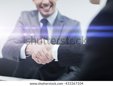 Image, Stock Photo Two young men shake hands. Close up of the hands in front of a green background.