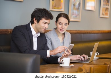 Business-team Working On Laptop At Coffee Bar, Looking A Mobile Phone