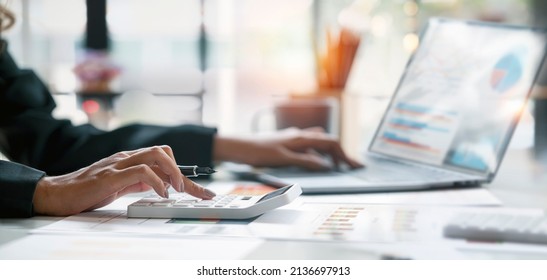 Businesswoman or accountant working Financial investment on calculator, calculate, analyze business and marketing growth on financial document data graph, Accounting, Economic, commercial concept. - Powered by Shutterstock