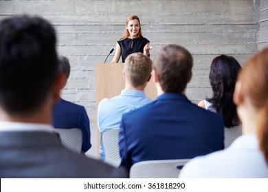 Businesswoman Addressing Delegates At Conference - Powered by Shutterstock