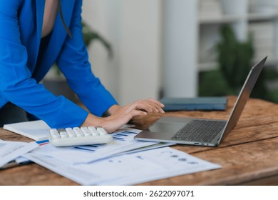 Businesswoman Analyzing Financial Data with Laptop