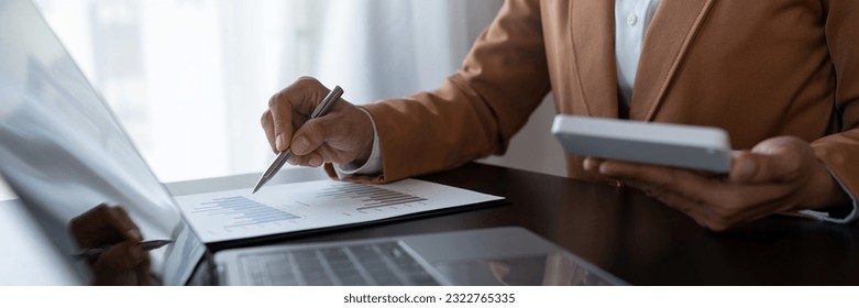 Businesswoman analyzing income charts and graphs with laptop computer. business analysis and strategy concept Business statistics, profit, financial growth rate on graph paper. financial data chart - Shutterstock ID 2322765335