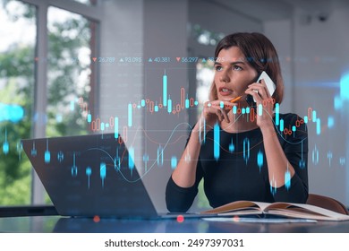 Businesswoman analyzing stock market data on a laptop while talking on the phone. Transparent graphs and data overlay. Business and technology - Powered by Shutterstock