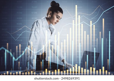 Businesswoman analyzing stock market data on a laptop with financial charts and graphs overlay. Professional setting. Concept of financial analysis - Powered by Shutterstock