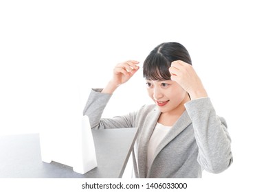 Businesswoman Arranging Hair Style Image