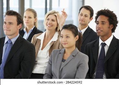 Businesswoman Asking Question During Presentation