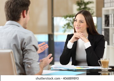 Businesswoman attending listening to a client who is talking at office