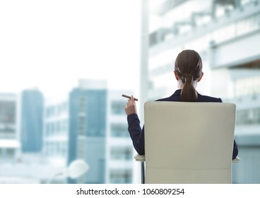 Businesswoman Back Sitting in Chair with cigar and buildings - Powered by Shutterstock