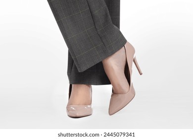 Businesswoman in beige shoes on white background, closeup - Powered by Shutterstock