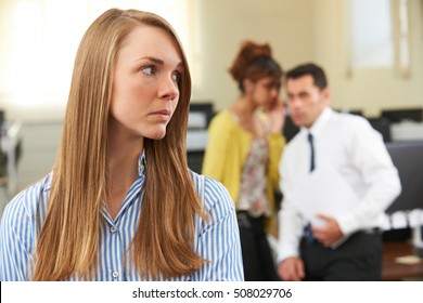Businesswoman Being Gossiped About By Colleagues In Office - Shutterstock ID 508029706