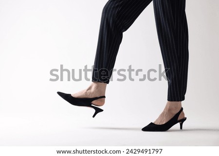 Businesswoman in black shoes on white background, closeup