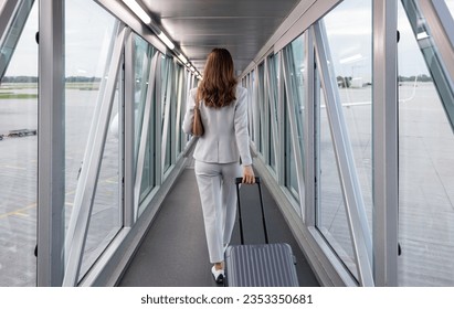 Businesswoman boarding the plane with carry-on - Powered by Shutterstock