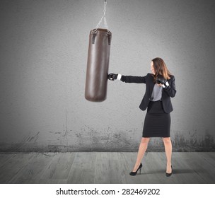 Businesswoman is boxing and punching a bag - Shutterstock ID 282469202