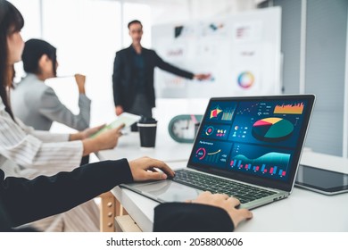 Businesswoman in business meeting using laptop computer proficiently at office for marketing data analysis . Corporate business team collaboration concept . - Shutterstock ID 2058800606