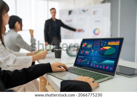 Businesswoman in business meeting using laptop computer proficiently at office for marketing data analysis . Corporate business team collaboration concept .