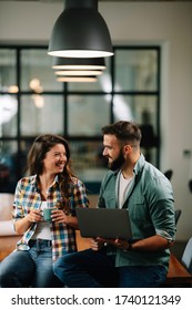 Businesswoman And Businessman Drinking Coffe In Office. Young Man And Woman Having Coffee Break.