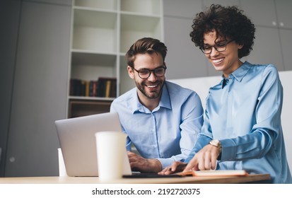 Businesswoman and businessman looking something in notebook. Concept of business cooperation and teamwork. Young smiling caucasian millennial people at table in office. Modern successful people - Shutterstock ID 2192720375